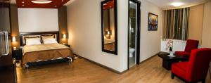 Postel nebo postele na pokoji v ubytování Plaza Sur Hotel & Suites