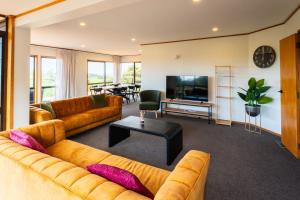 a living room with a couch and a television at Chapman House in Auckland