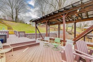a wooden deck with chairs and a gazebo at Duck and Bugs Cabin on Boone Lake with Boat Dock! in Piney Flats