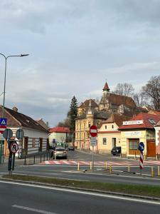 a street in a town with a car on the road at SIAN Sanctuary Villa in Braşov