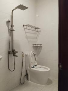 a bathroom with a toilet and a shower in it at Hotel Bông Sen in Ho Chi Minh City