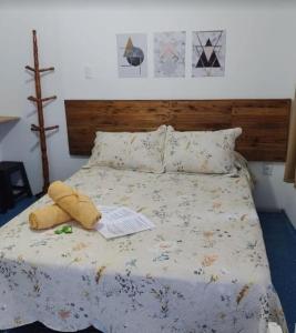 a bedroom with a bed with a stuffed animal on it at Suites Mar Azul Prainha in Arraial do Cabo