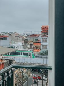 a train on a track in a city with buildings at Yen’s House in Hanoi