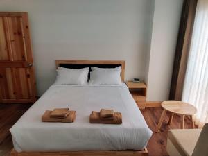 a bedroom with a bed with two towels on it at Happy apartment in Thimphu