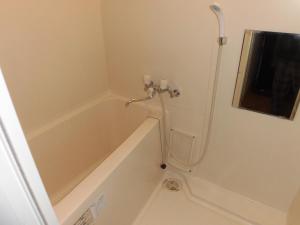 a bathroom with a bath tub with a shower at ETERNAL/F　sapporo803 in Sapporo +16 photos