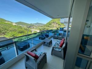a balcony of a cruise ship with chairs and tables at Apto Samaria Club de Playa, encanto del mar in Santa Marta