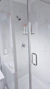a shower with a glass door in a bathroom at 3bed 1 bath suite - Surrey Fleetwood in Surrey