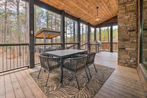 a screened porch with a table and chairs on it at Family Getaway 10-Bed Cabin w Hot tub & Firepit in Broken Bow