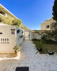 a courtyard with a gate and a building with plants at vibrant bright house of La Marsa in La Marsa