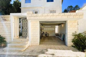 a house with a bike parked in a garage at vibrant bright house of La Marsa in La Marsa