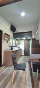 a kitchen with a table and a chair in a room at Tiny house Alto bosque in Pucón