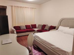 a living room with a bed and a couch at Arnim Suite - 3 Bedrooms Apartment in Sharjah