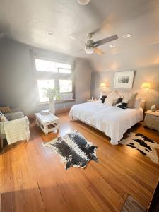 a bedroom with a bed with a cow rug on the floor at Off Broadway B & B in Denver