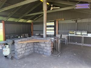 a room with tables and chairs and a stone fireplace at Kangaroo Lake C & C Park 
