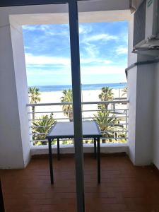 a table in a room with a view of the beach at Barraca Suites in Valencia