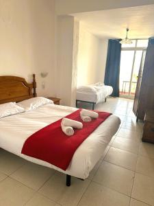 a hotel room with two beds with towels on it at Barraca Suites in Valencia