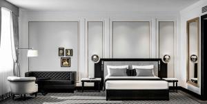 a black and white bedroom with a bed and a chair at GoldenEye Hotel & Casino in Svilengrad