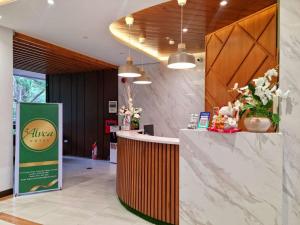 a lobby of a coffee shop with a counter at Alvea Hotel and Residences in Baguio