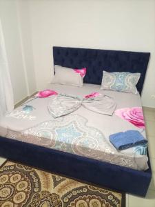 a bed with many pillows on top of it at Appartement bord de mer in Pointe-Noire