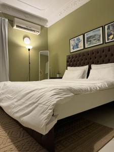 a bedroom with a large bed with white sheets at Beautiful 1BHK Near Jumeirah near Metro 3mins walk in Dubai