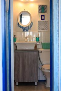 a bathroom with a sink and a toilet and a mirror at Lovely apartment close to everything with a view! in Viña del Mar +19 photos
