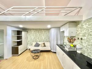 a kitchen and living room with a couch in a room at Phuc Khang Apartment in Ho Chi Minh City