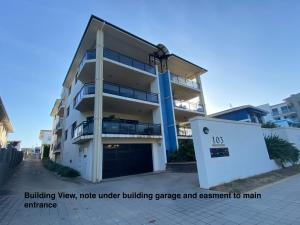 a building view node under under building garage and apartment to main entrance at Townsville Lighthouse - 3/103 Strand in Townsville