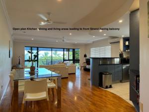 a kitchen and living room with a table and chairs at Townsville Lighthouse - 3/103 Strand in Townsville