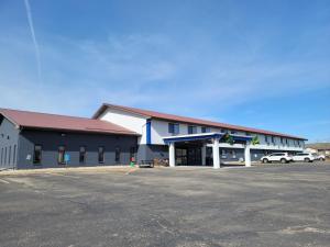 a building with a parking lot in front of it at Quality Inn in New London