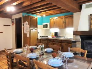 a kitchen with a table with chairs and a dining room at Gîte Sauvain, 4 pièces, 6 personnes - FR-1-496-94 in Sauvain