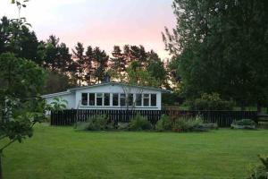 a white house with a fence in a yard at Ako Retreat 