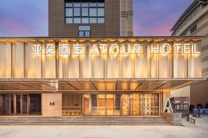 a hotel with a sign on the front of it at Atour Hotel Meizhou Meixian Baili Plaza in Meizhou