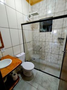 e bagno con doccia, servizi igienici e lavandino. di Chalé Vista do Paraíso a Gonçalves
