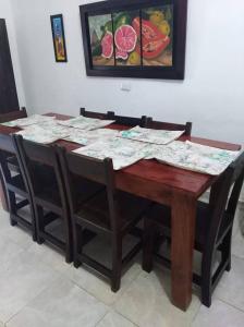 a wooden table and chairs with papers on it at Villa Concha in Pueblo Bello