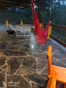 a patio with two hammocks and a stone floor at Irakara hotel campestre in La Palma