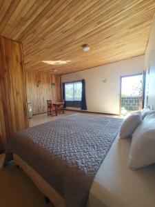 a bedroom with a large bed with a wooden ceiling at El Chagüite monteverde #2 in Monteverde Costa Rica +23 photos