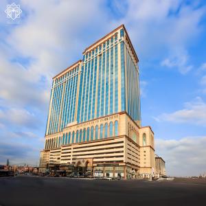 a tall building with a lot of windows at Manarat Gaza Hotel - Al Haram Tower in Mecca