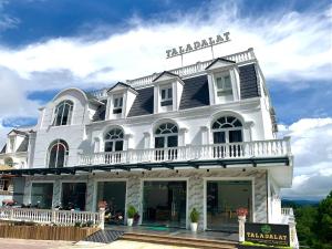 a large white building with a sign on it at Tala Dalat Hotel in Da Lat