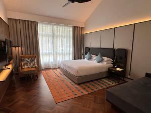 a bedroom with a bed and a large window at Lone Pine, Penang, a Tribute Portfolio Resort in Batu Ferringhi