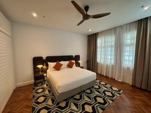 a bedroom with a bed and a ceiling fan at Lone Pine, Penang, a Tribute Portfolio Resort in Batu Ferringhi