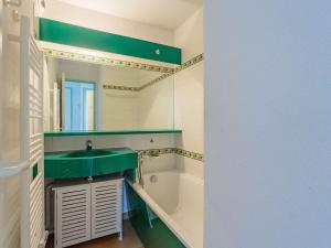 a bathroom with a green sink and a bath tub at Grand appartement familial avec piscine près de Saint-Jean-de-Luz - FR-1-2-439 in Urrugne +6 photos