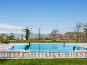 a large swimming pool in a park with a fence at Grand appartement familial avec piscine près de Saint-Jean-de-Luz - FR-1-2-439 in Urrugne