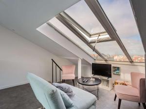 a living room with a skylight and a tv at Appartement Rénové Quartier des Halles Biarritz - FR-1-3-604 in Biarritz
