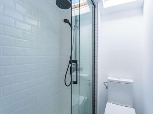 a bathroom with a glass shower with a toilet at Appartement Rénové Quartier des Halles Biarritz - FR-1-3-604 in Biarritz +7 photos