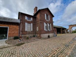 ein altes Backsteinhaus mit einer Kopfsteinpflasterstraße in der Unterkunft Gîte Sains-du-Nord, 6 pièces, 11 personnes - FR-1-510-204 in Sains-du-Nord