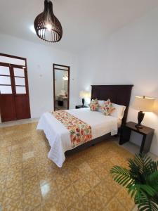 a bedroom with a bed and a potted plant at CASA XTABENTUN in Mérida