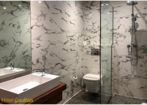 a bathroom with a sink and a toilet and a shower at Boutique Hotel Gauthier Restaurant Terrasse in Casablanca