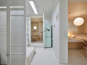 a room with a refrigerator and a bedroom at Hygge - Urban Hideout with four comfort beds in Seoul