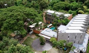 an overhead view of a building with a pool and trees at Proud Phu Fah Muang Chiang Mai in Chiang Mai