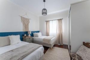 a bedroom with two beds and a window at View Point: Ocean Views & Near CBD in Burnie